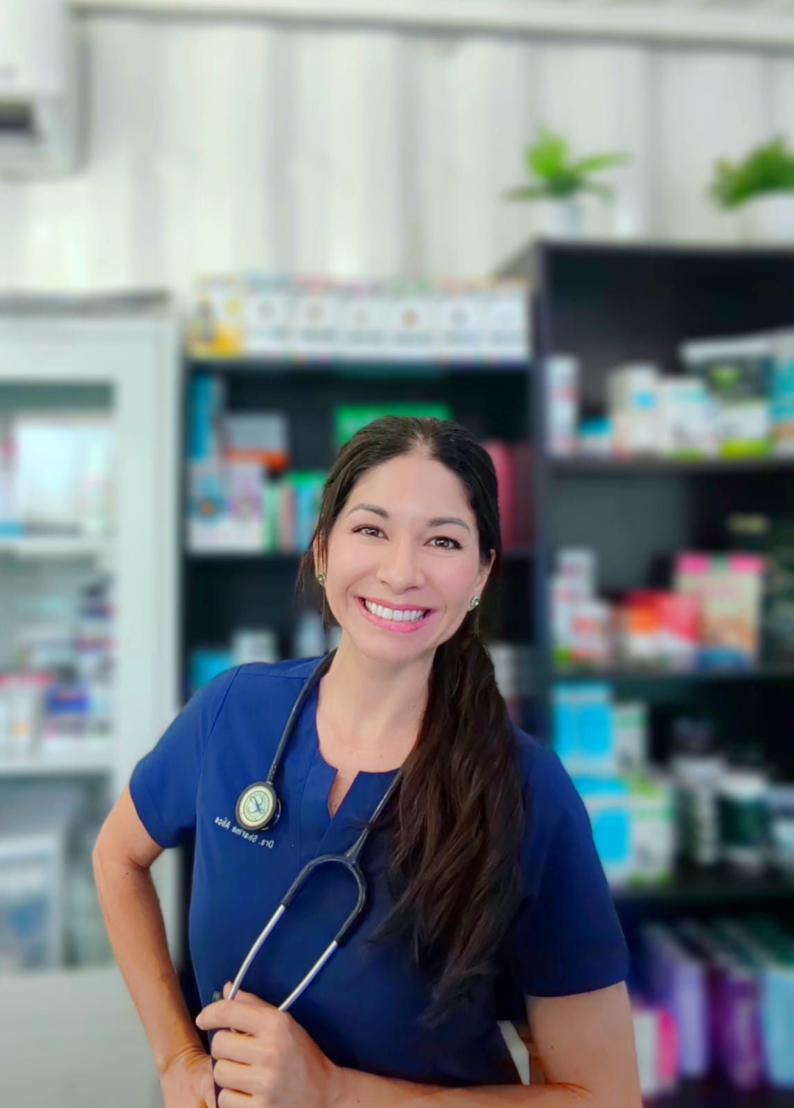 Dr. Sharine Alice in navy scrubs at her clinic pharmacy
